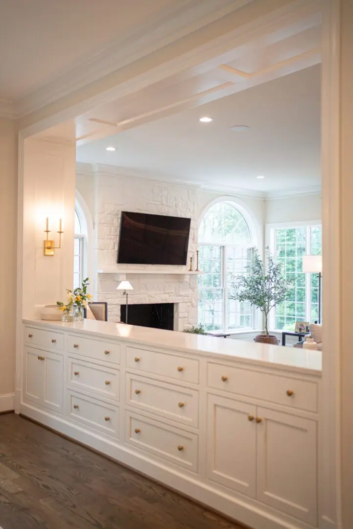 A room with white cabinets and a fireplace.