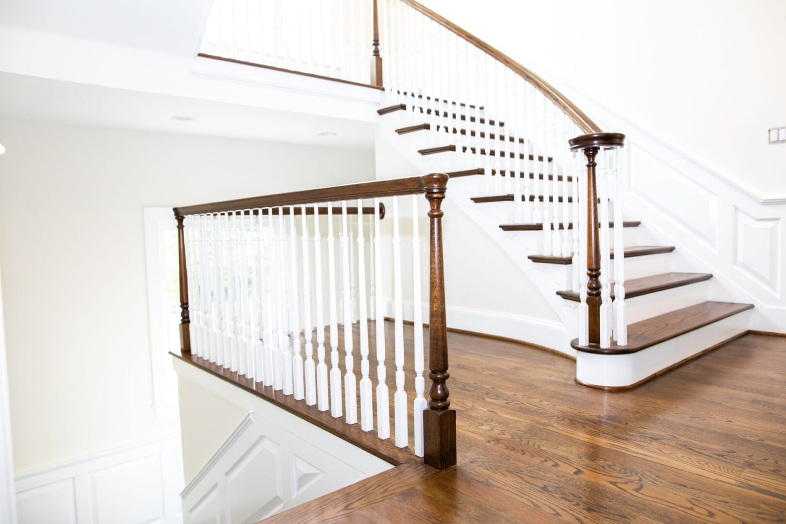 A wooden staircase with white railing and wood steps.