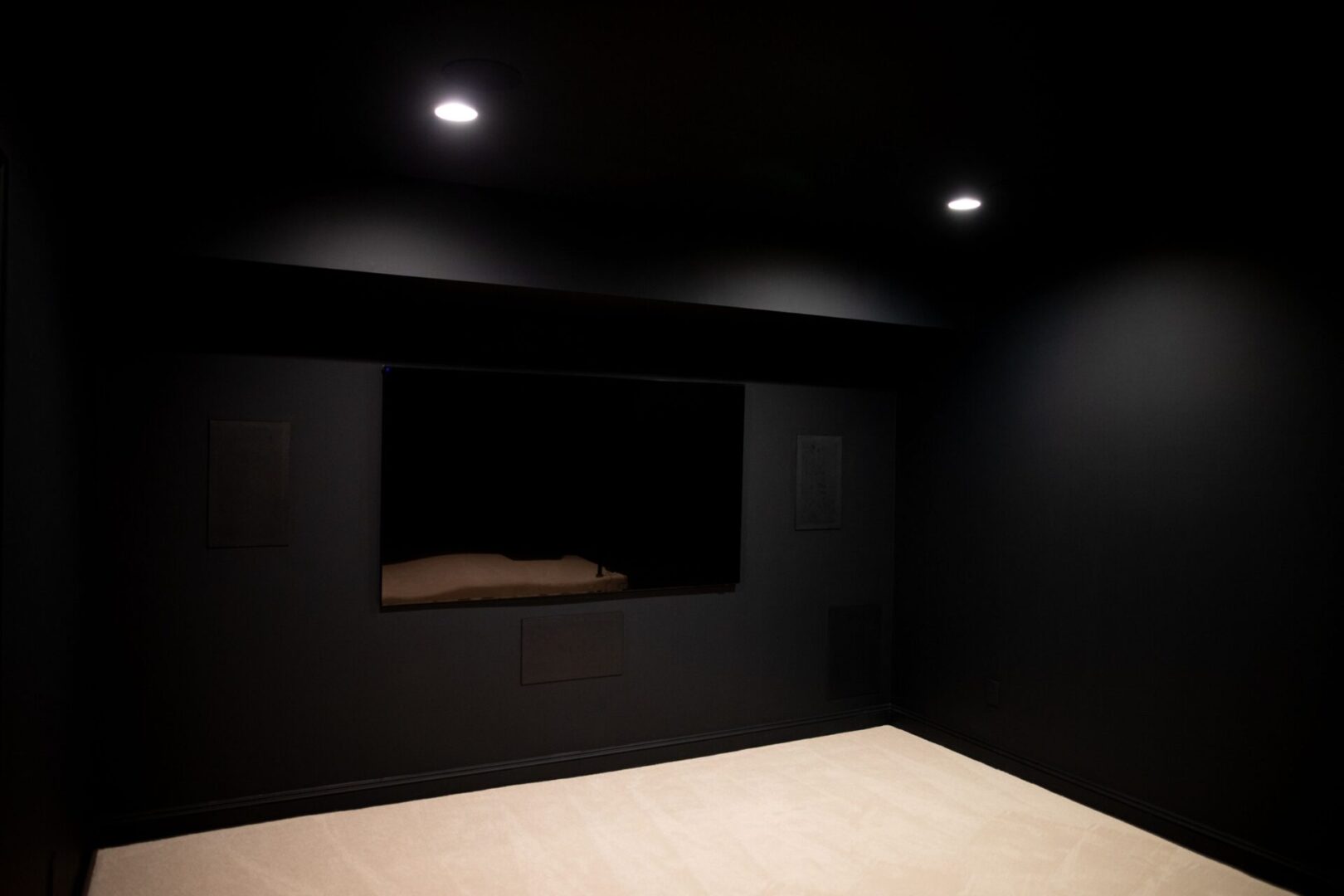 A room with black walls and white tile floor.