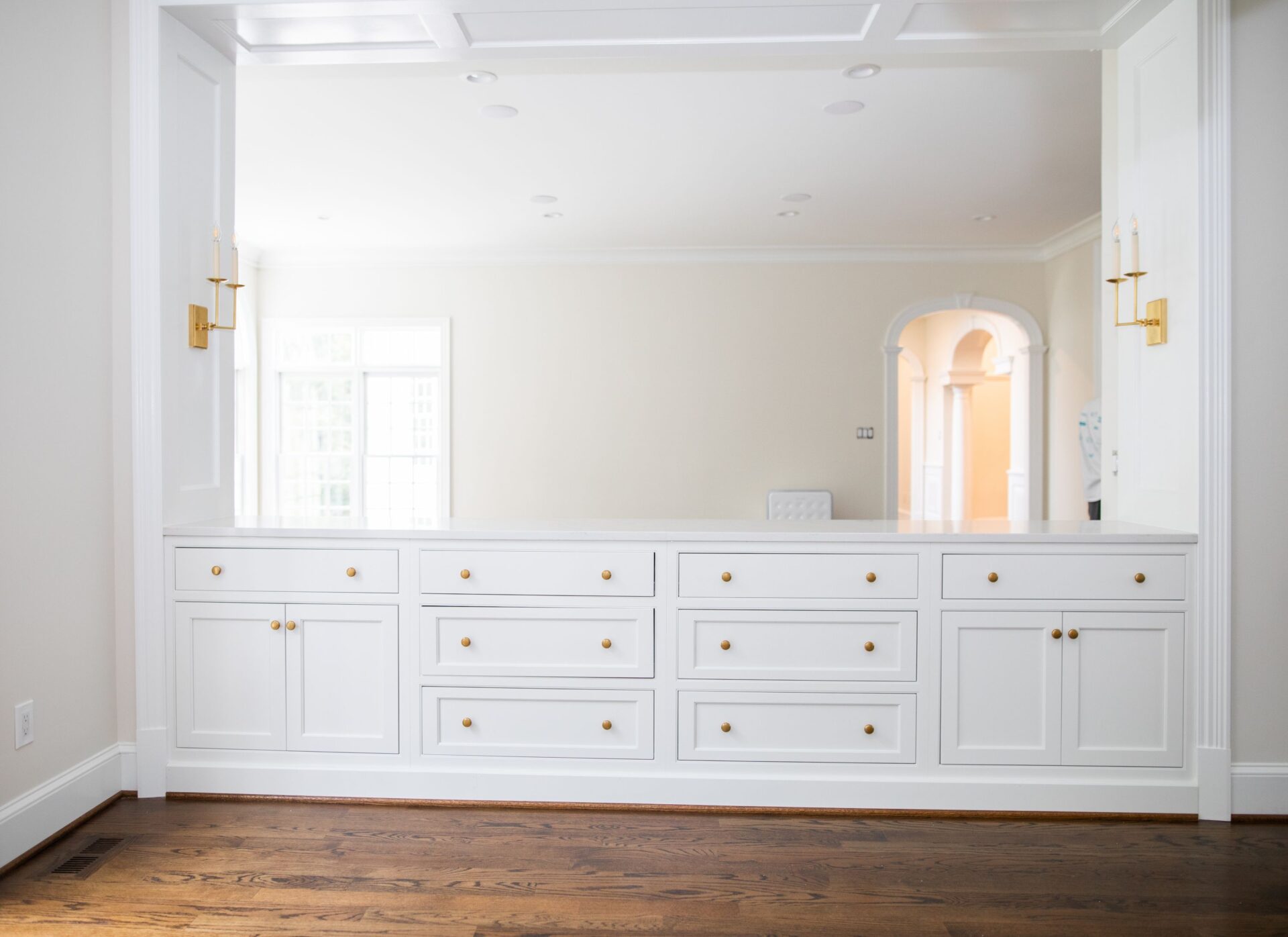 A white room with many drawers and a mirror